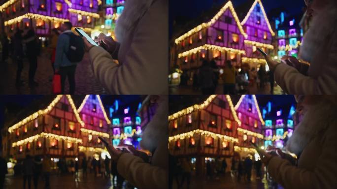 一位女士在热闹的圣诞市场边走边玩她的智能手机