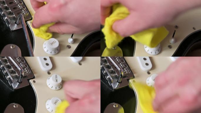 一名男子正在清洗装有白色拾音器的黑色电吉他。吉他服务理念。