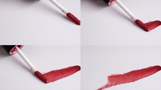 化妆液红色唇彩、唇膏涂抹、涂抹、笔画。在白色背景上涂抹唇彩。化妆品的广告。