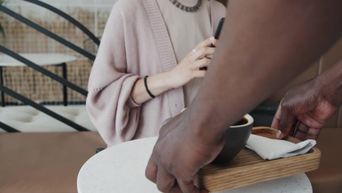 面目全非的服务员端着咖啡托盘给白人妇女