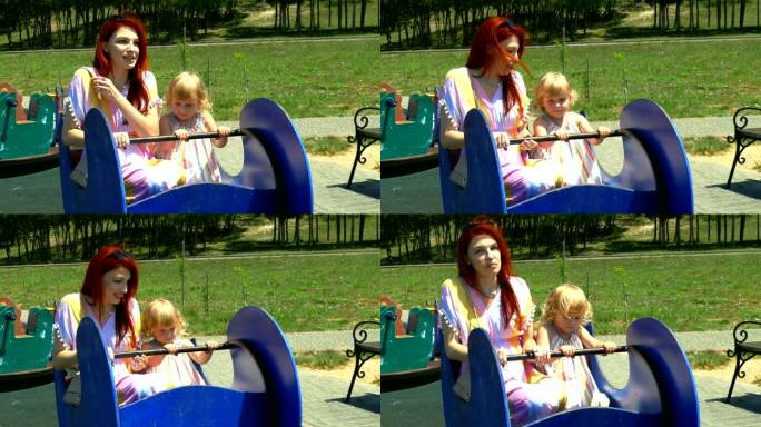 一个女人带着一个小女孩在儿童公园里荡秋千
