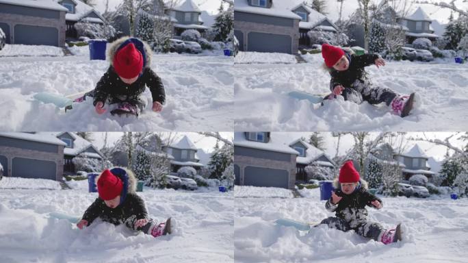 可爱的小女孩在她家门前的雪地里玩耍