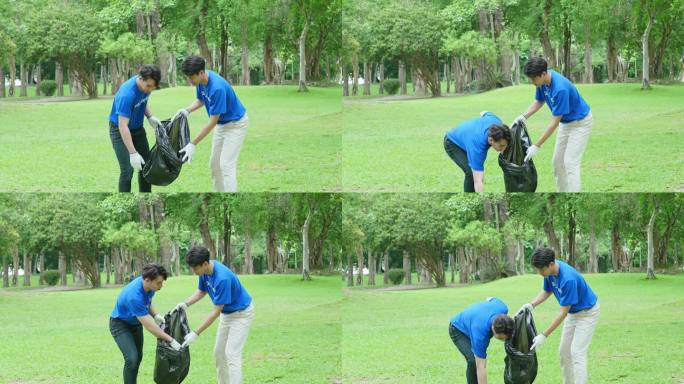 多民族志愿者拿着黑色垃圾袋收集塑料垃圾，以减少公园的污染。