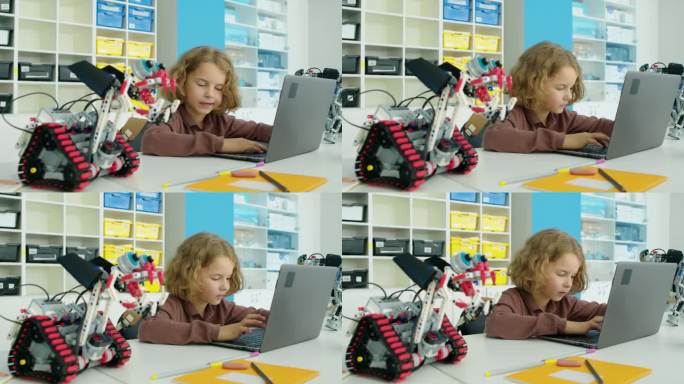 青春期前的白人男孩在笔记本电脑上为电动机器人编写软件