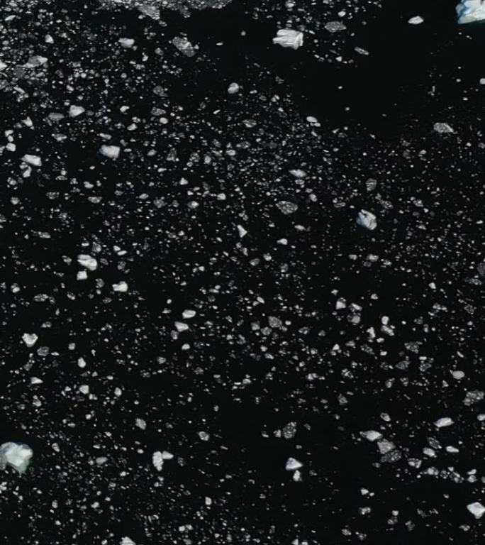 垂直视频南极洲南极海洋黑暗水域上的小冰屑。