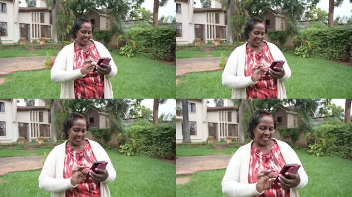 东非高级妇女在自家花园里发短信