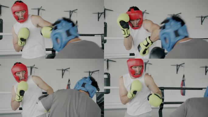 慢动作的年轻人拳击伙伴一起训练，戴着头盔和手套在健身房拳打脚踢
