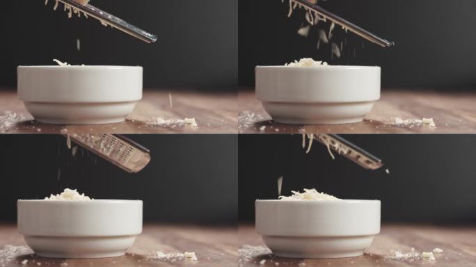 木桌上白色碗里陈年帕尔马干酪的慢镜头特写