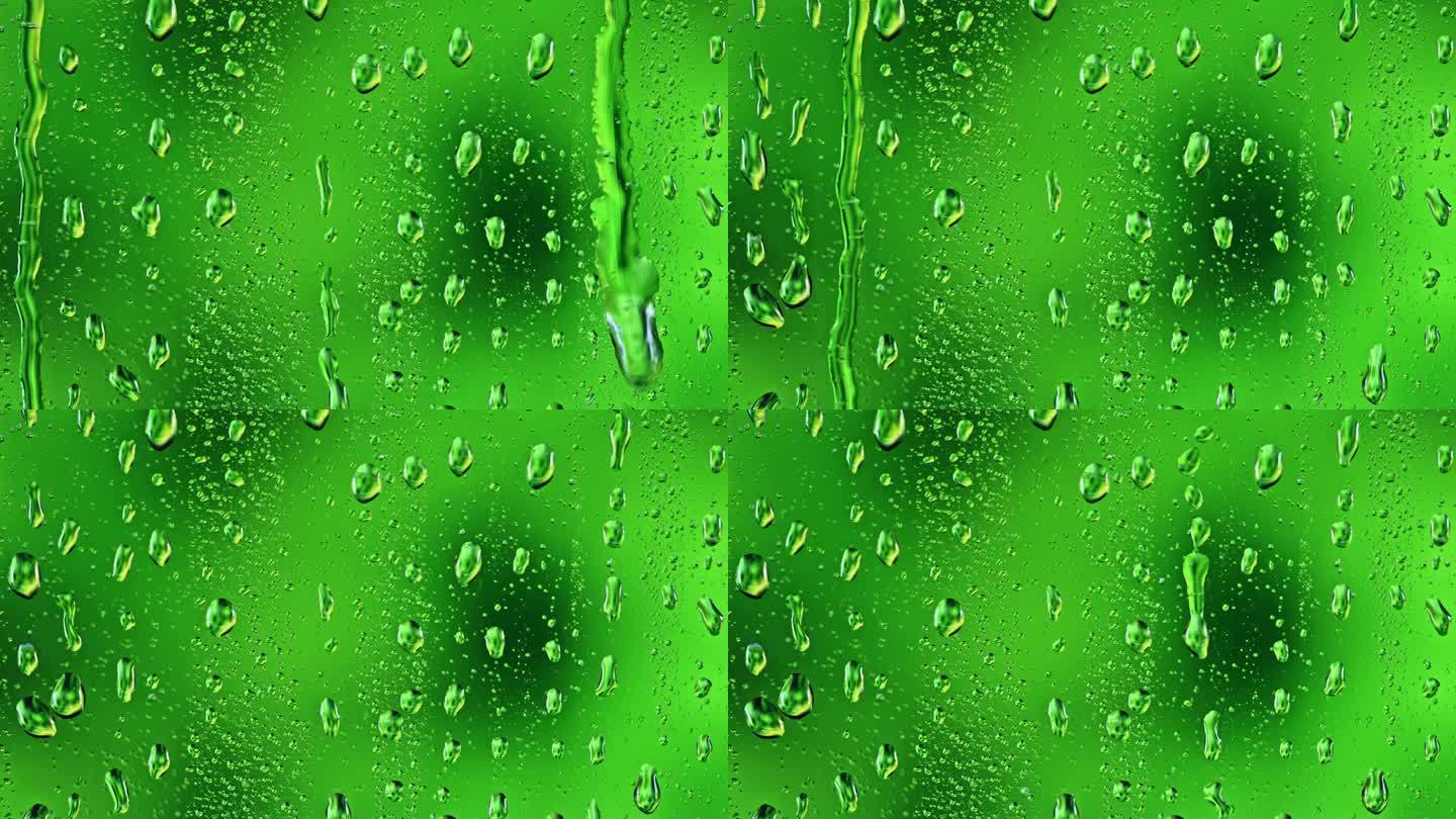 雨点在绿色的背景下从窗户滑下