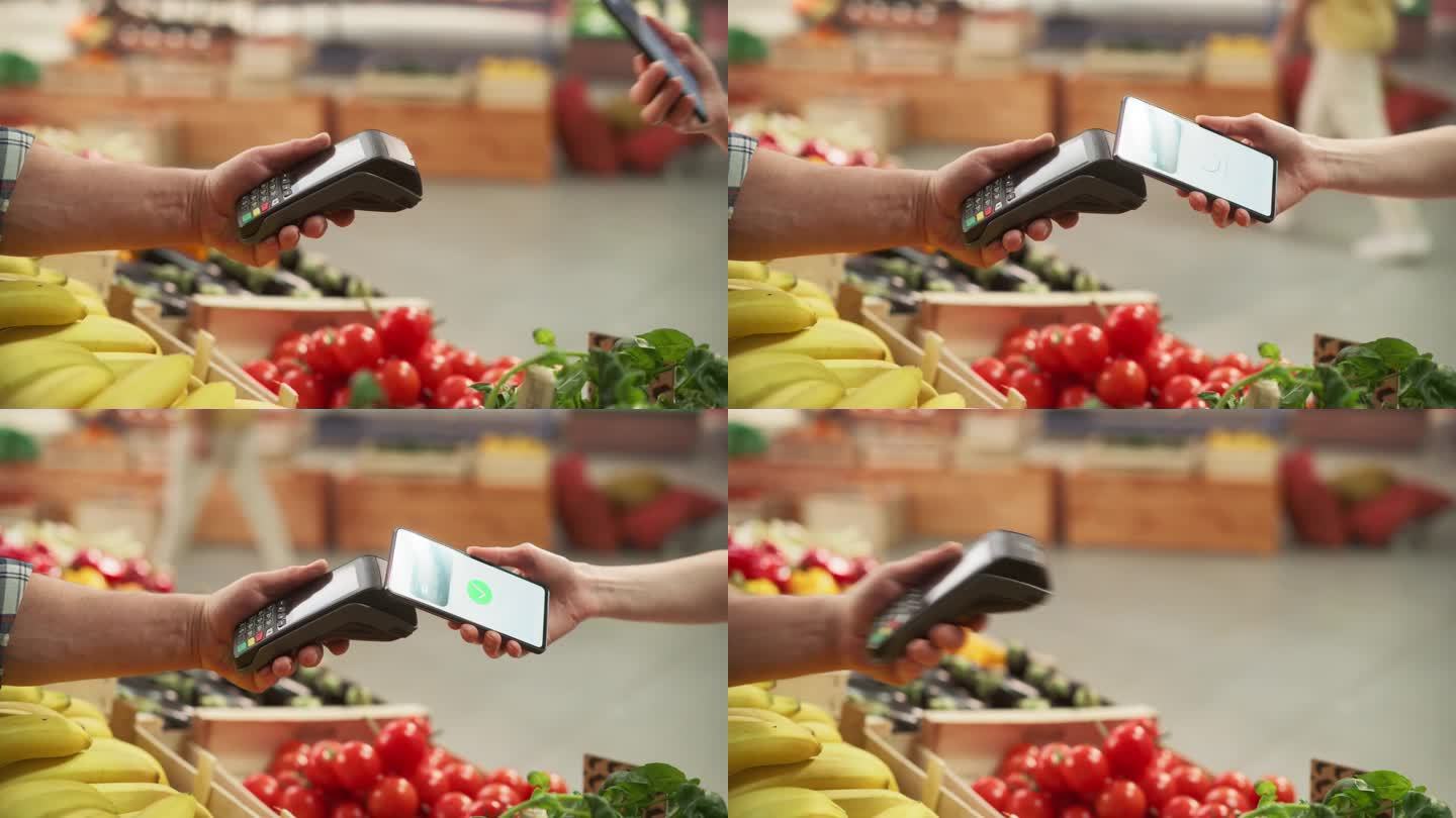 一位顾客使用带有信用卡银行NFC应用程序的智能手机进行安全的非接触式在线支付的特写。现代购物者从农贸