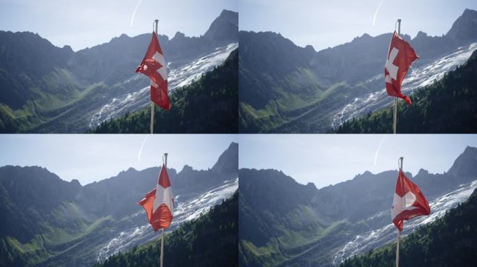 风中飘扬着瑞士国旗，身后是冰川和阿尔卑斯山