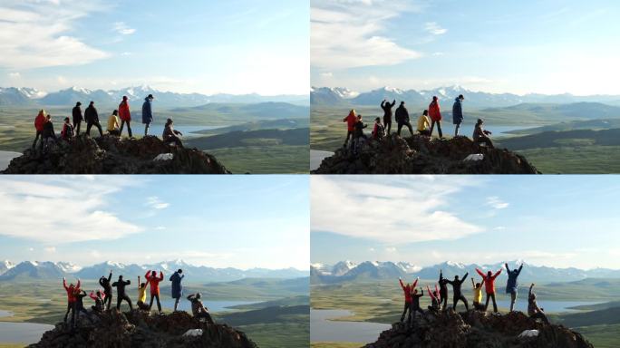 旅行团一起在山顶上举起手，欢呼成就后景