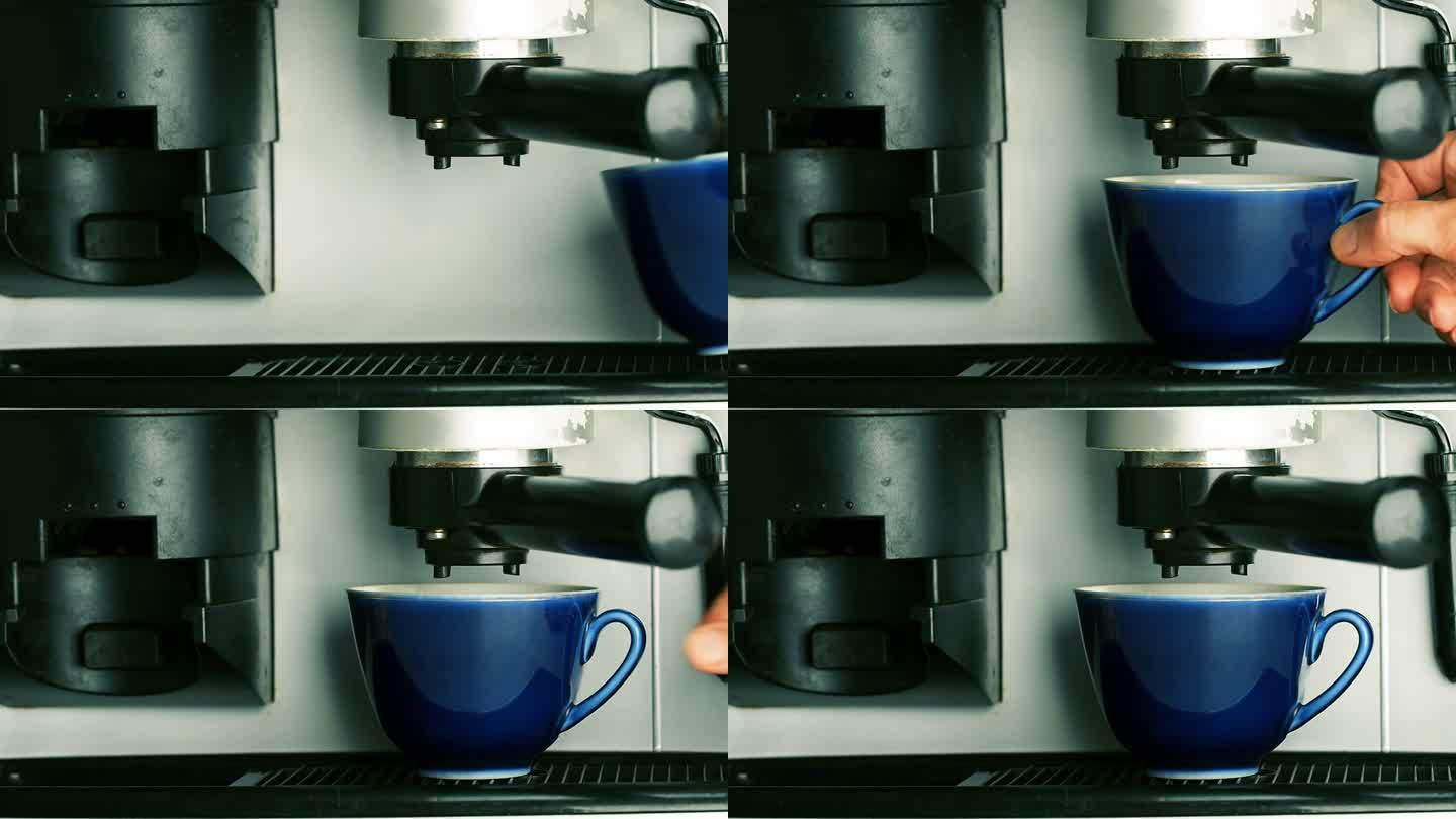 浓缩咖啡机，特写，一个女人的手把一个蓝色的杯子放在喇叭下面