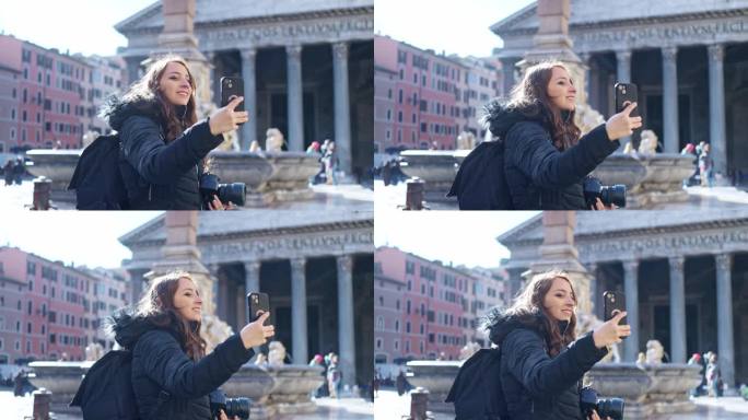 在意大利罗马的万神殿前，穿着保暖衣服的年轻拉丁女子站在智能手机上用专业相机自拍，目光移开