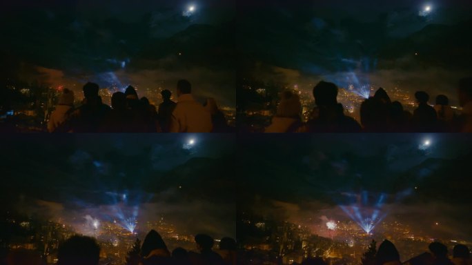 人们在除夕夜欣赏采尔马特被烟花和激光照亮的景色