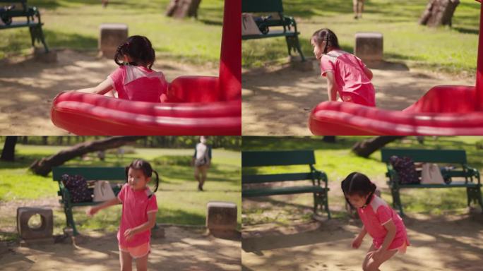 快乐的亚洲小女孩在户外操场上从滑块的顶部滑到地面。在学校或幼儿园操场上玩耍的孩子。活泼的小孩在五颜六