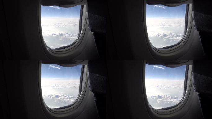 从云层上的飞机窗口看出去