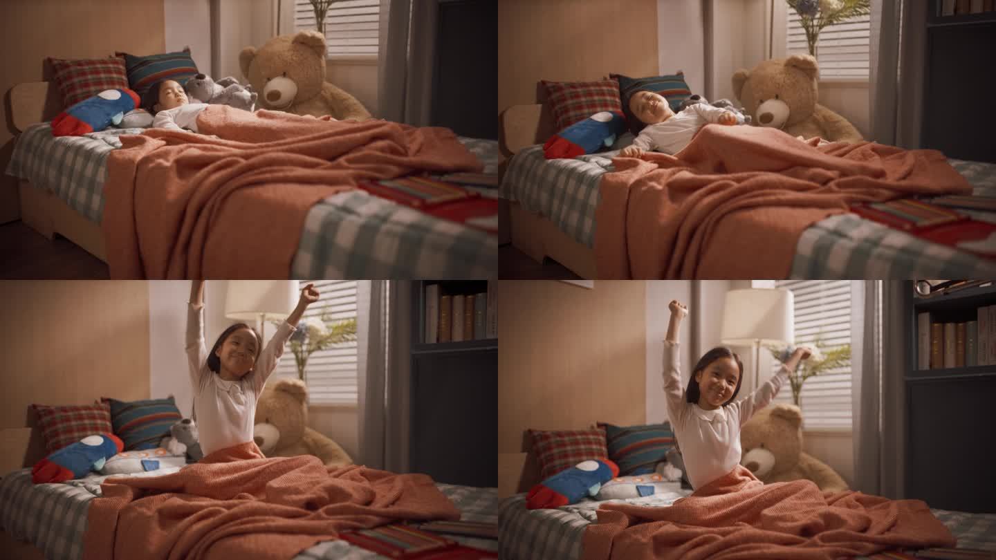 一个可爱快乐的韩国女孩在她可爱的房间里小睡后醒来的肖像。小孩坐在床上，抱着毛绒玩具，伸展双臂，可爱地