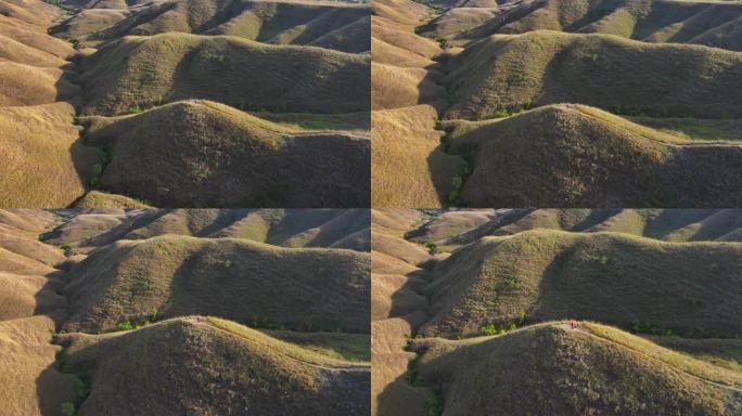 空中无人机拍摄的印尼松巴岛武吉沃林丁草地和山丘的日出景象