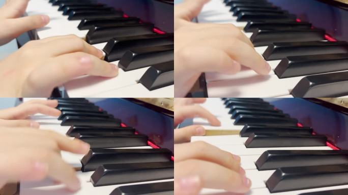 特写人物弹钢琴。只有手和钥匙可以看到。一个小男孩在弹钢琴