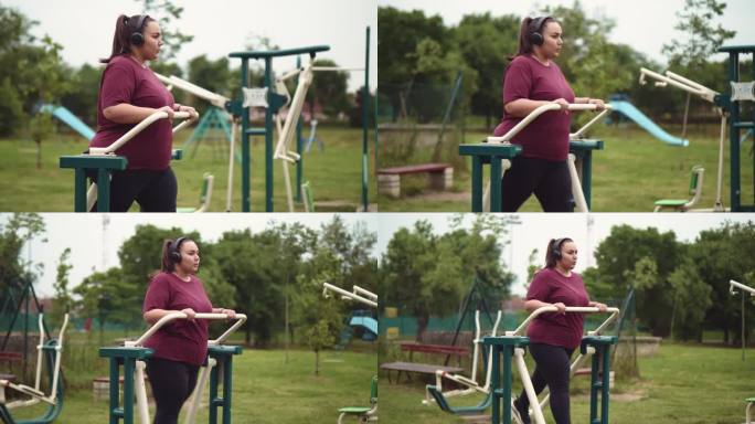 一名戴着耳机的超重年轻女子在室外健身房里的椭圆机上锻炼。