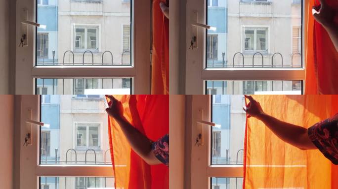 双手拉上橙色的百叶窗