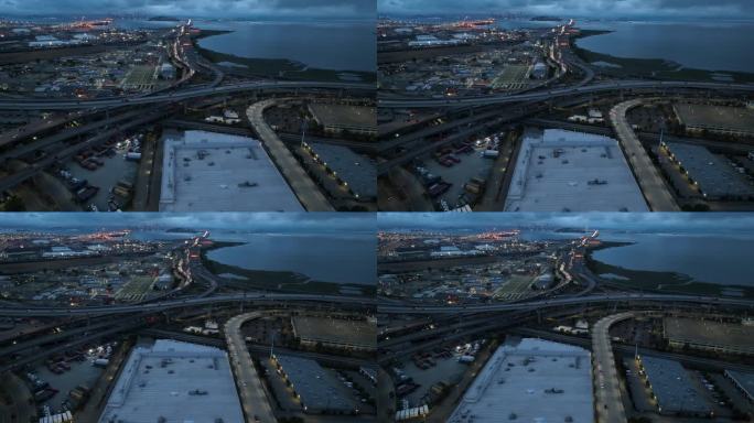 晚上，无人机俯瞰行驶在滨水区管制高速公路上的汽车