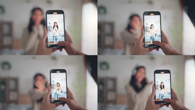 快乐的年轻亚洲视频博主和她的朋友一起用智能手机相机拍摄舞蹈视频，在社交媒体上分享视频