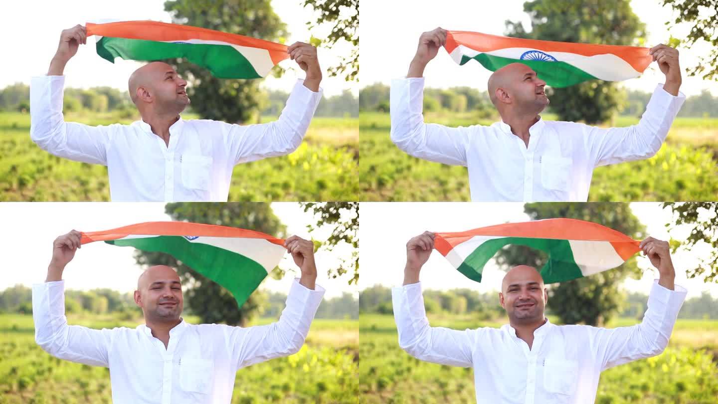 人们在屋外的农田里挥舞着印度国旗