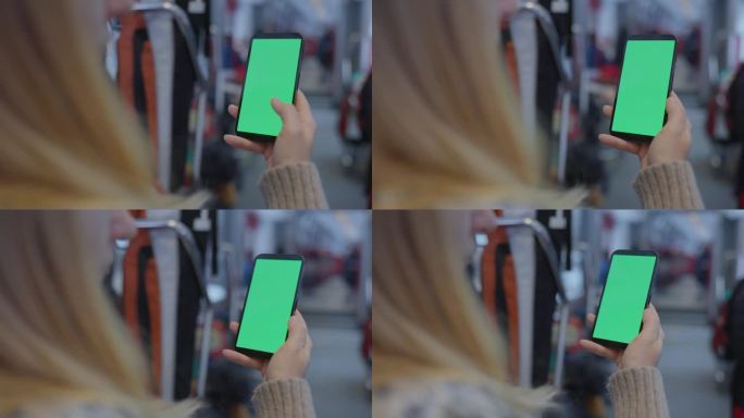 MS Woman在乘坐火车时使用带有彩色键屏的智能手机