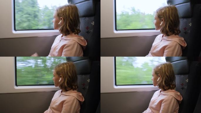 小女孩在火车上透过窗户往外看