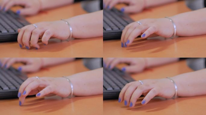 一个涂着蓝色指甲的女人紧张地用手指敲着桌子。焦虑易怒的上班族，电脑对人心理状态的负面影响