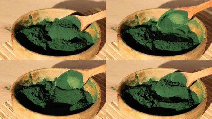 竹生态碗中的蓝绿藻、小球藻和螺旋藻粉。超级粉在勺子里。排毒超级食品。藻类的天然补充