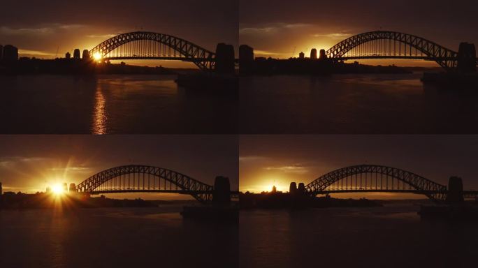 在金色的冬日日出中，广阔的背光映衬出悉尼海港大桥的剪影