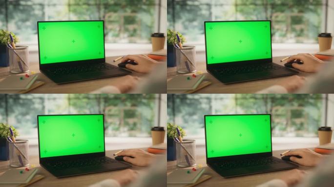 匿名创意项目经理在笔记本电脑上工作，模拟绿色屏幕Chromakey显示与运动跟踪占位符。视频模板的内