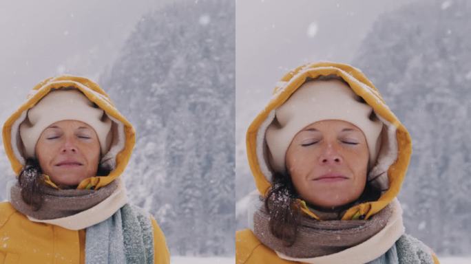 女人在冬日的雪景中享受着新鲜的空气