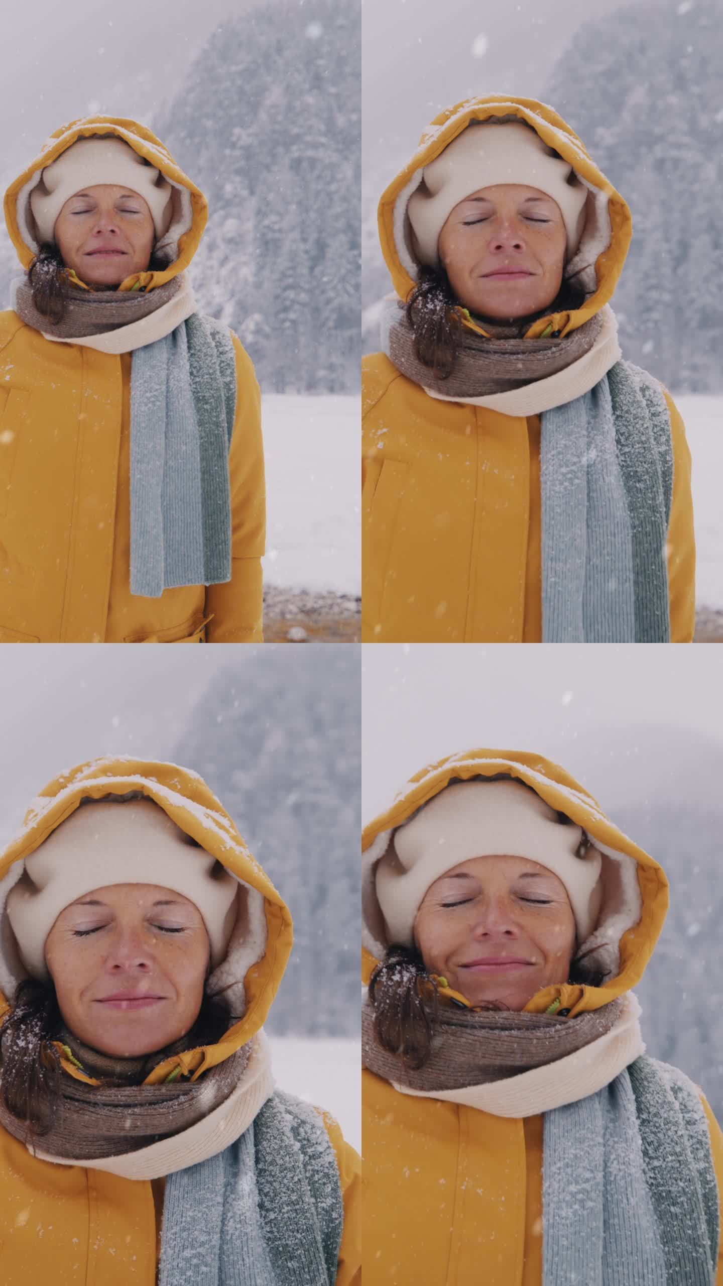 女人在冬日的雪景中享受着新鲜的空气