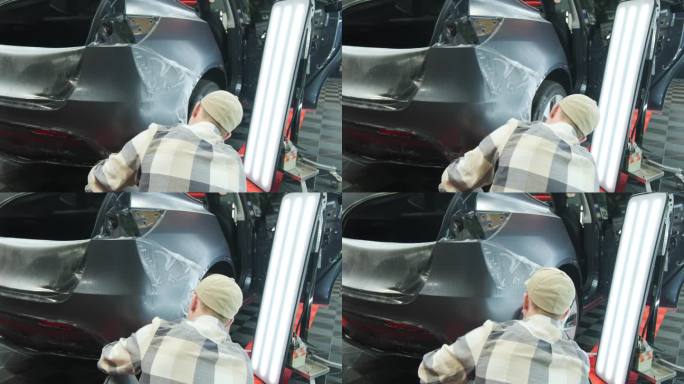 将PPF保护膜涂在汽车上的过程。在汽车上涂保护膜的工人。