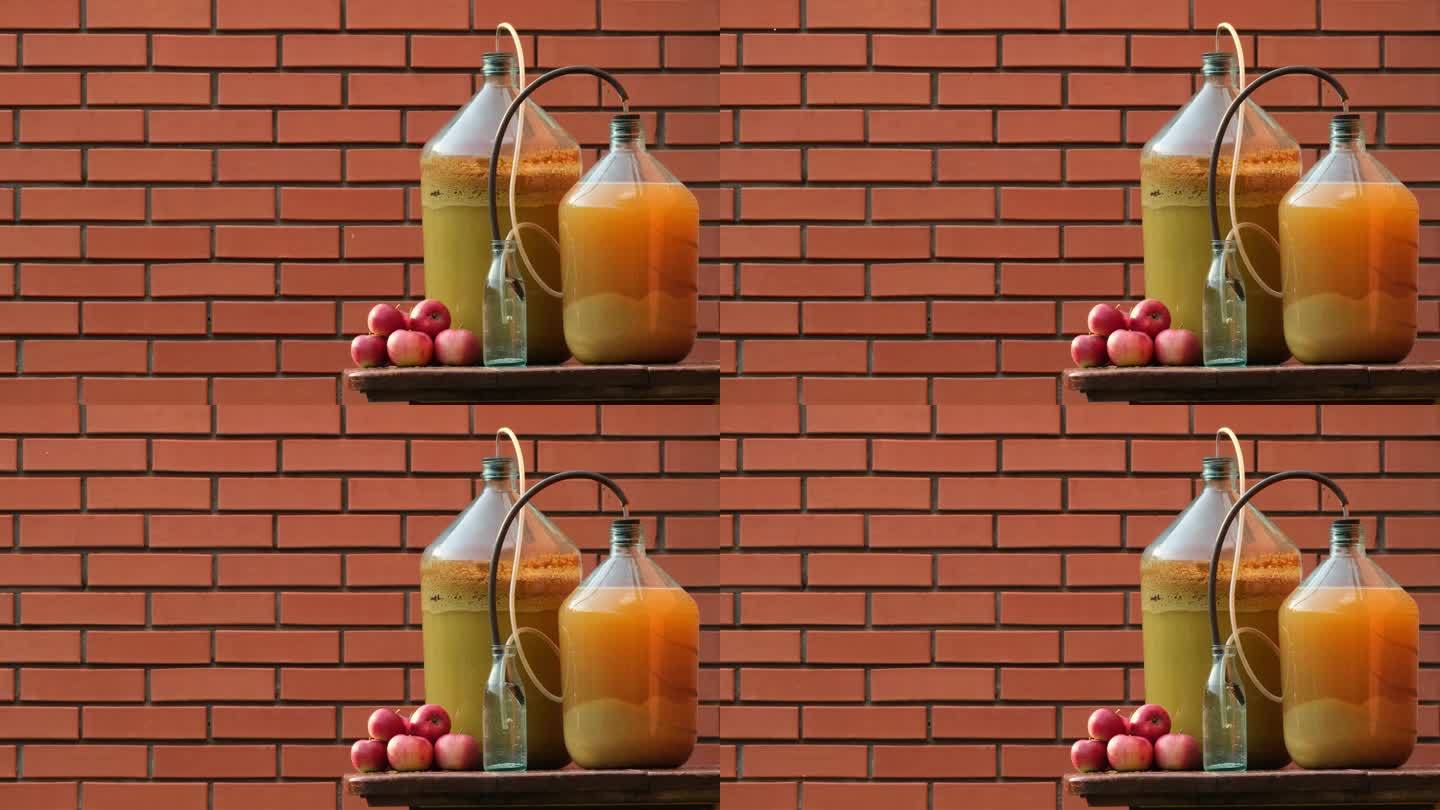 苹果酒。瓶中的苹果酒泡沫，发酵。苹果麦汁在发酵罐中，有一个原始的气锁。农民在家酿造苹果酒，户外特写