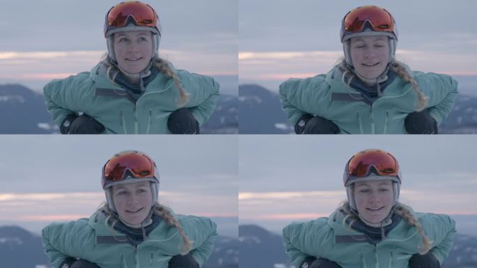 靠在滑雪杆上微笑的女滑雪者