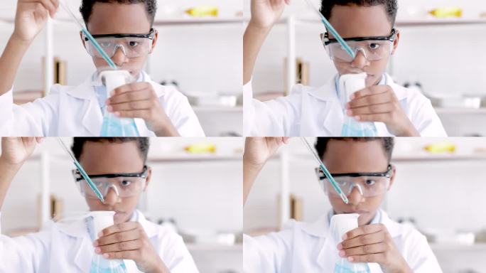小学生在小学科学课上做化学实验时，戴着防护眼镜，穿着实验服，用挤压管从烧瓶中挤出水，分析和混合玻璃中