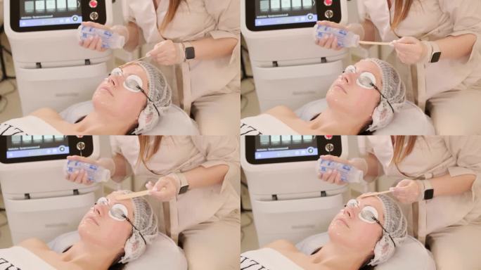 一名妇女在美容中心接受眼部周围的射频提拉手术，以恢复面部皮肤的活力