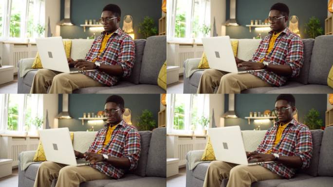 年轻的非洲裔美国人在家用笔记本电脑工作