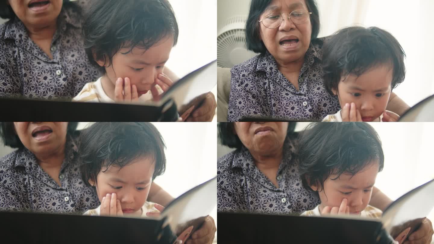 亚洲小孩在兴致勃勃地读书，戴眼镜的奶奶和孙子在家里读童话。