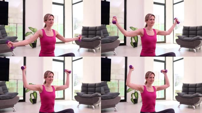 活跃的运动女性用哑铃锻炼肌肉和肱二头肌