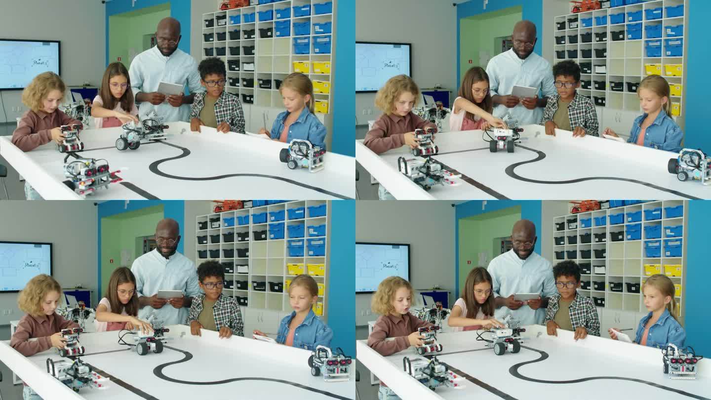 一群不同的孩子在课后技术俱乐部玩机器人模型