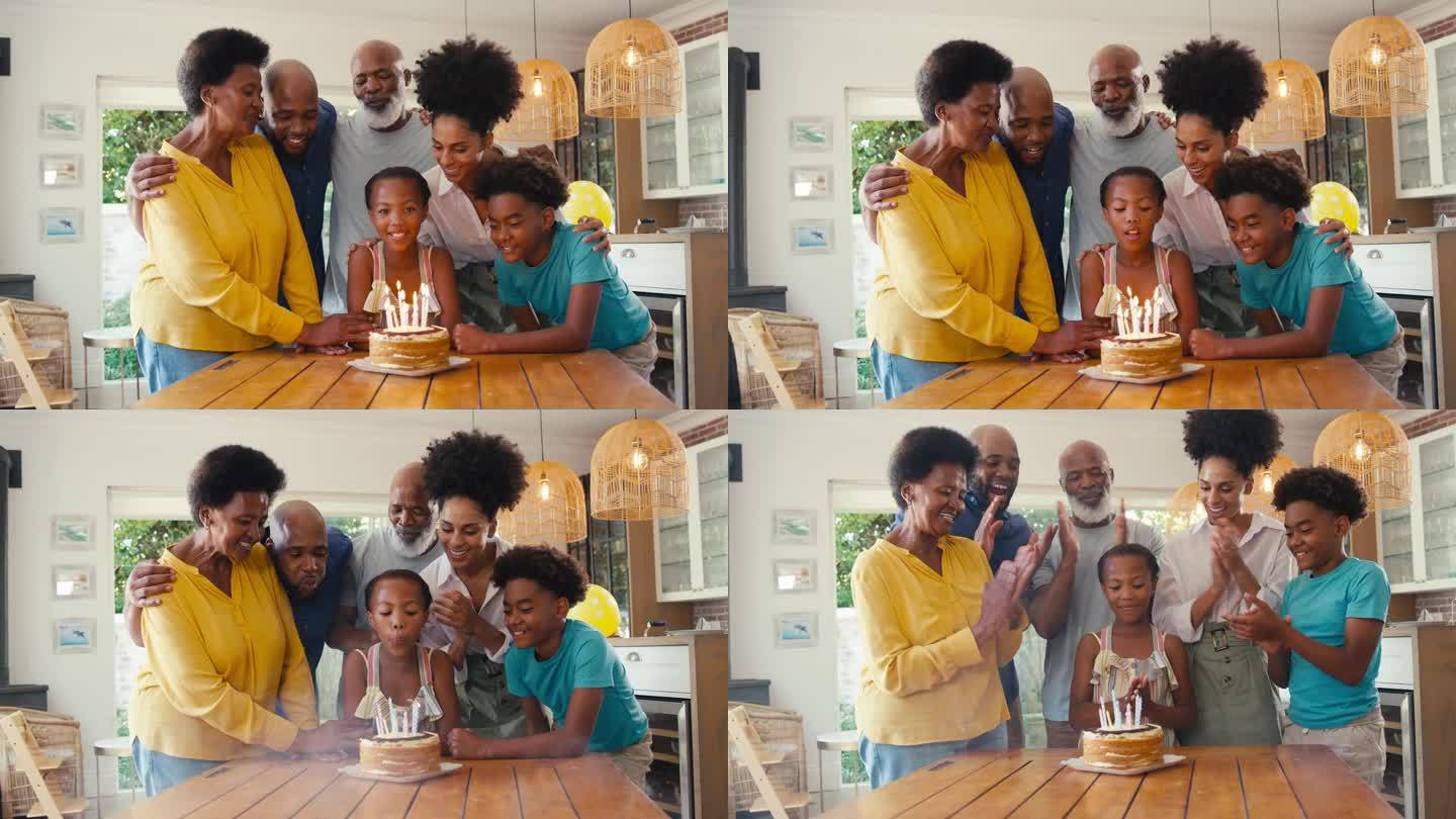 几代同堂的家庭在家里用蛋糕和蜡烛庆祝孙女的生日