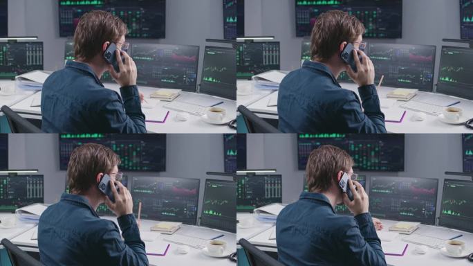 男性经纪人通过电话交谈，在电脑上处理实时股票