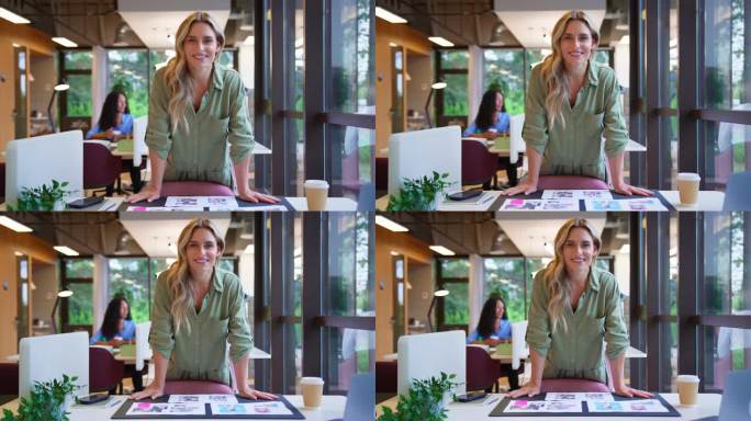 镜头向后拉，显示了一个成熟的女商人站在办公室的办公桌前批准版式或校样，喝着咖啡的肖像——慢镜头