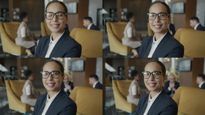 成功女企业家的肖像在酒店大堂室内微笑
